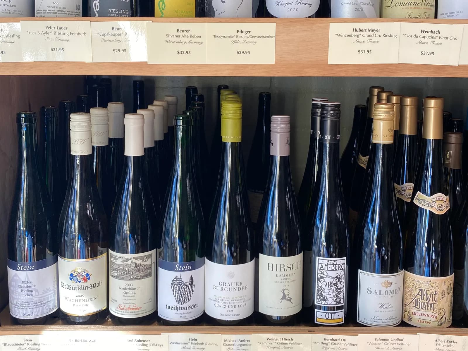Shelves of German and Austrian Rieslings with handwritten price tags at a Pasadena wine shop