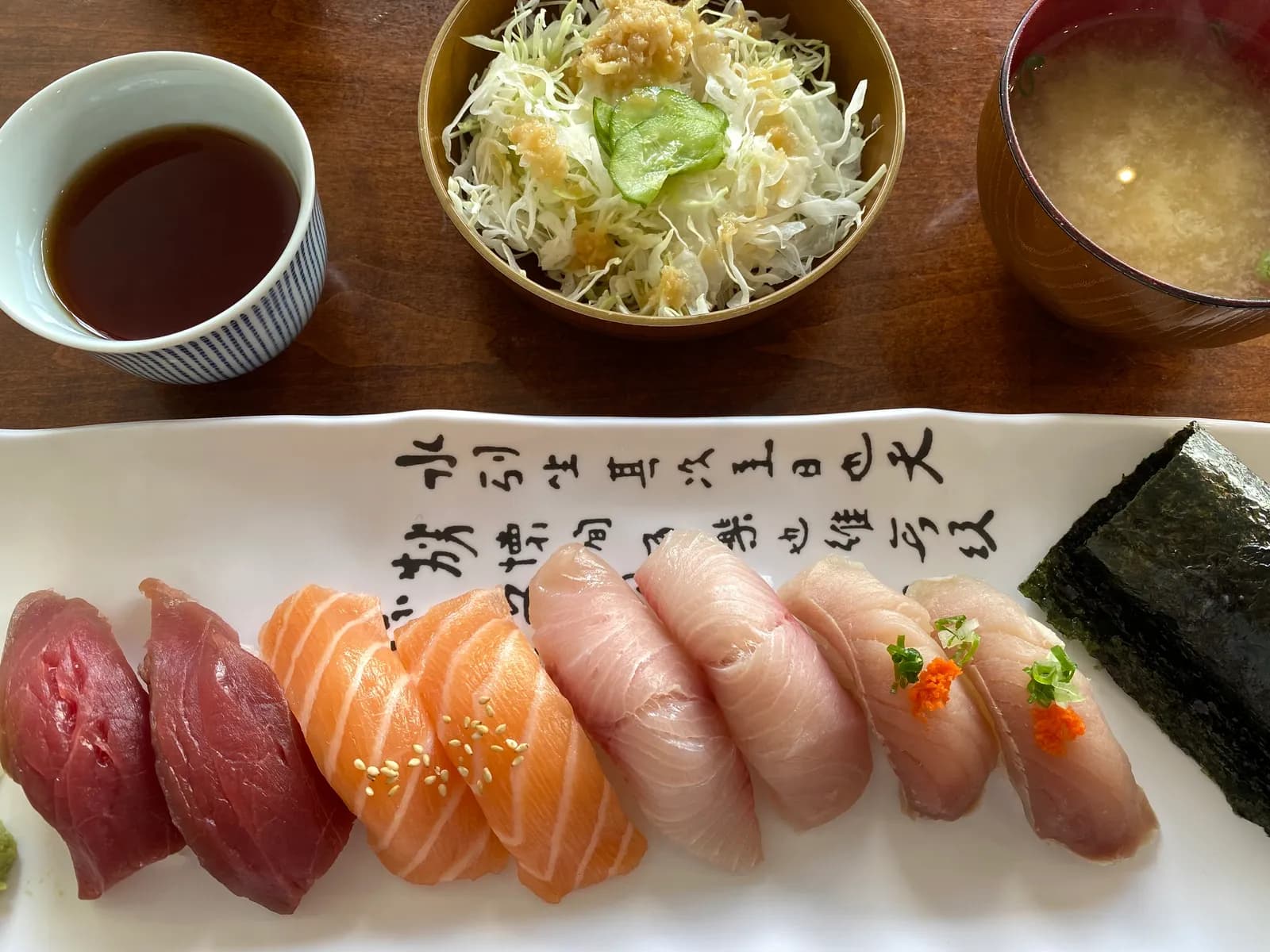 A nigiri lunch set with miso soup and salad at a Montrose sushi counter